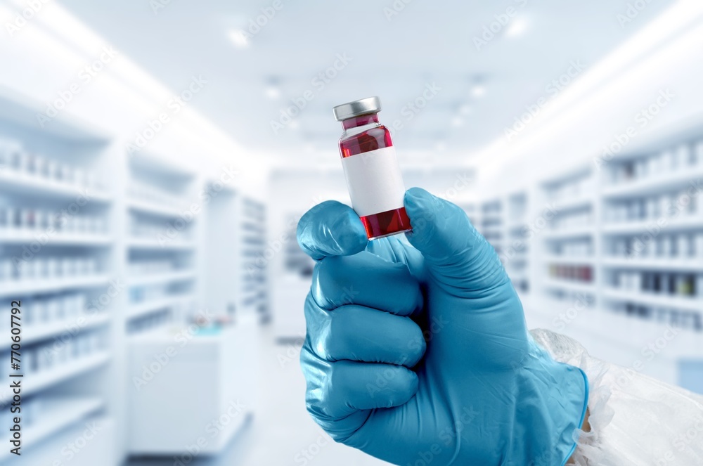 Experimental medical vaccine vial in doctor's hands