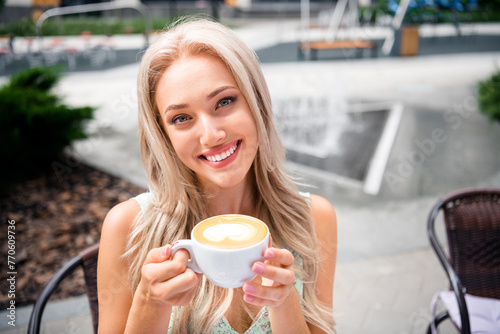 Photo of cute pretty shiny young girl holding cup tasty coffee latte enjoying free time moment vacation weekend springtime outside #770609736