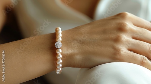 hand woman with a silver, gold , pearl bracelets