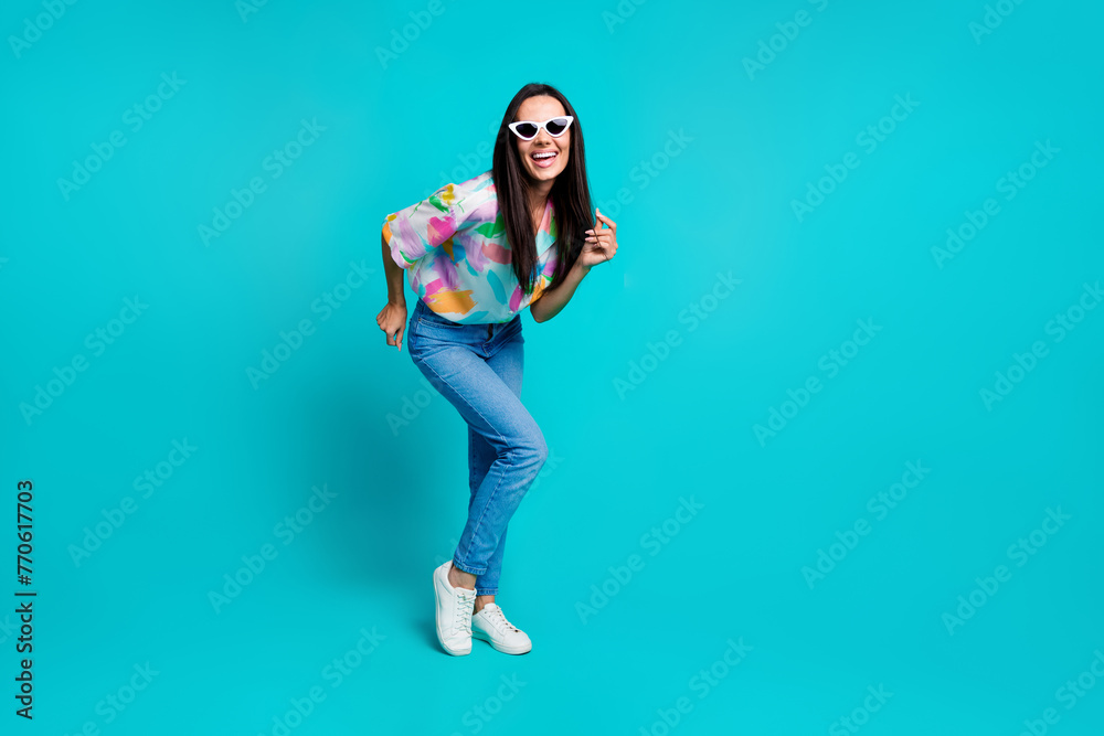 Photo of funny cheerful woman wear stylish print clothes have fun dance friday weekend isolated on cyan color background Photo of funny cheerful woman wear stylish print clothes have fun dance friday weekend isolated on cyan color background