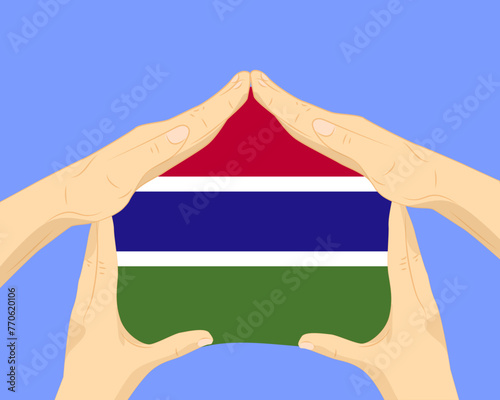 Hand home with Gambia flag, residential or investment idea, housing and home concept