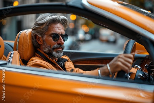 a stylish gentleman in his 30s seated inside an unbranded luxury car © Denis