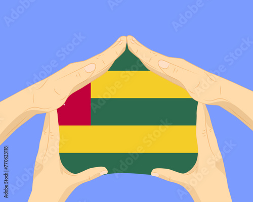 Hand home with Togo flag, residential or investment idea, housing and home concept