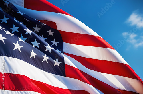 American flag waving in the wind on a background of blue sky