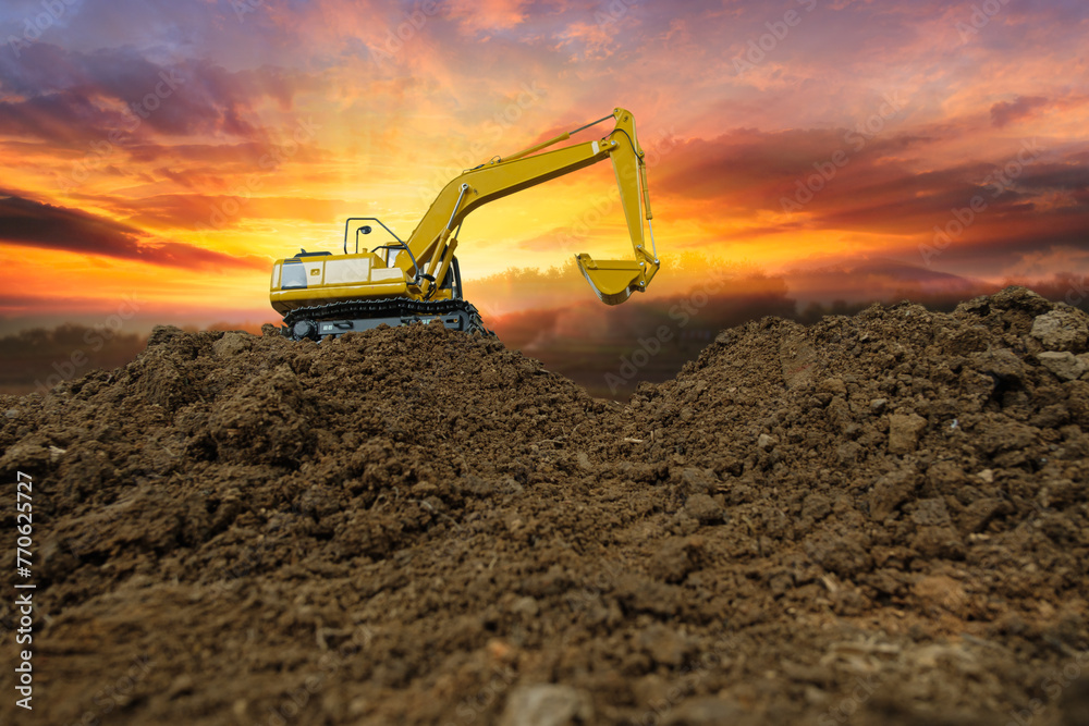 Crawler excavator with are digging the soil in the construction site on the sunset backgrounds - obrazy, fototapety, plakaty 