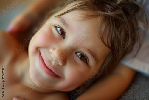 child with a smile getting a gentle touch massage © altitudevisual