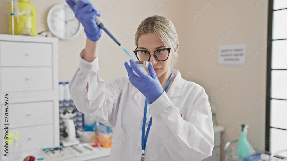 A focused woman scientist conducts experiments in a laboratory setting, showcasing research and healthcare dynamics in a clinical environment. A focused woman scientist conducts experiments in a laboratory setting, showcasing research and healthcare dynamics in a clinical environment.