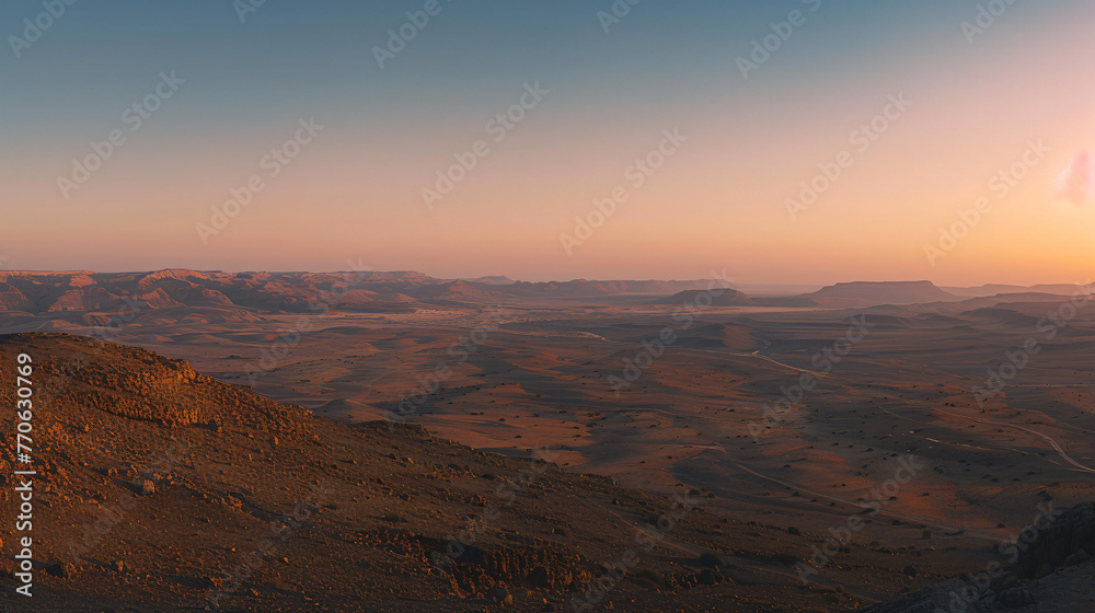 A panoramic view of a desert landscape at twilight with long shadows and soft pastel colors.