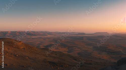 A panoramic view of a desert landscape at twilight with long shadows and soft pastel colors.