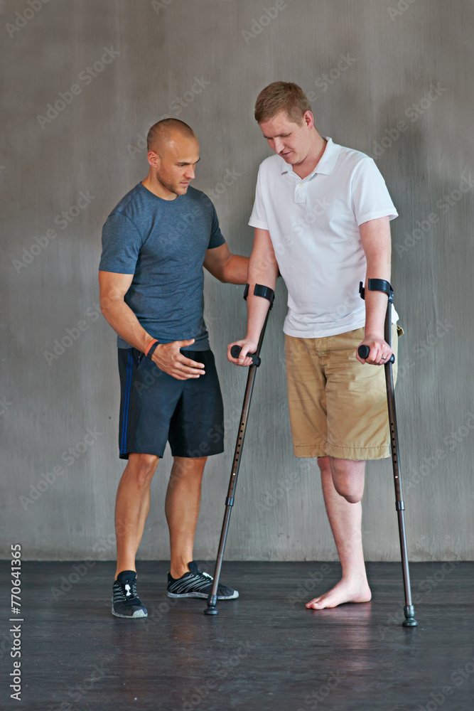 Physical therapy, crutches and patient with disability to exercise at clinic for recovery, strength and healthcare rehabilitation. Physiotherapist, support and consultation or workout for amputee - obrazy, fototapety, plakaty 
