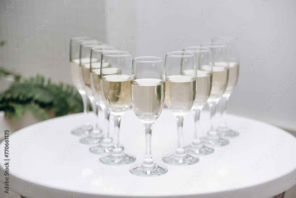 row of champagne glasses on buffet table