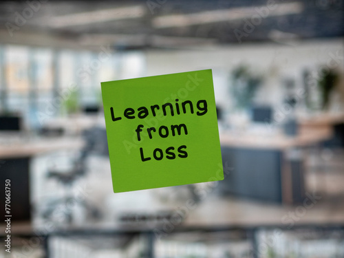 Post note on glass with 'Learning from Loss'.