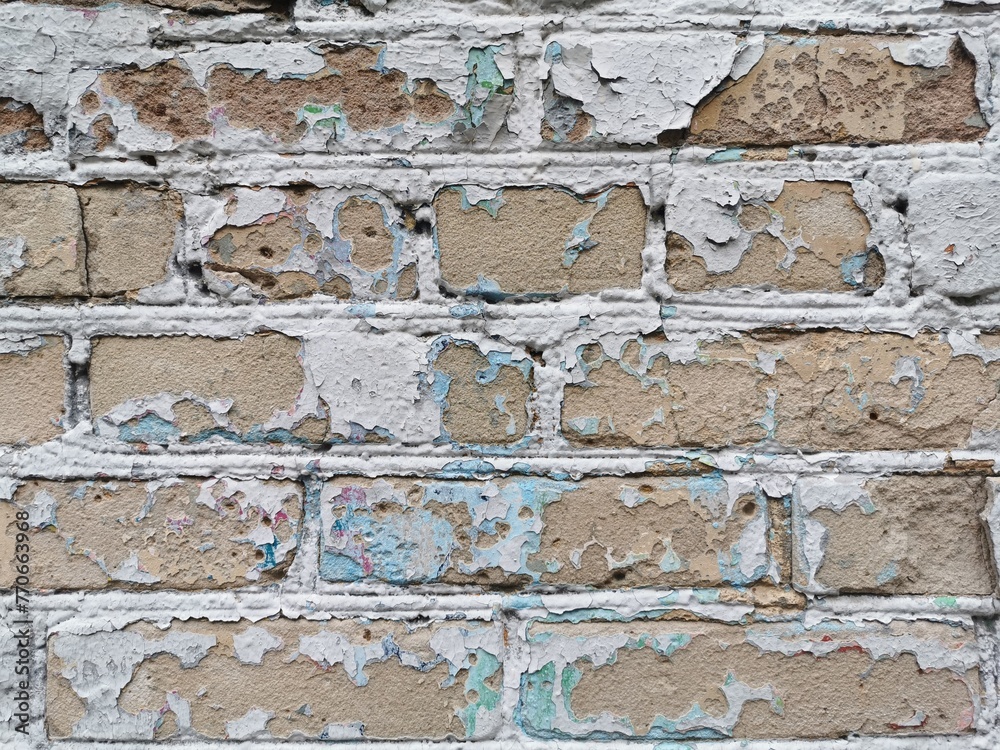 Fototapeta premium Wall with cracked paint. Old brick wall