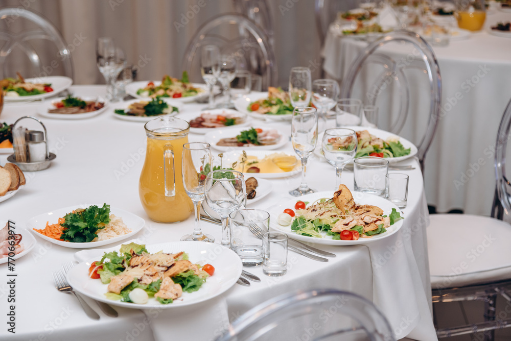 banquet table with plates of caesar salad