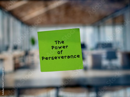 Post note on glass with 'The Power of Perseverance'.