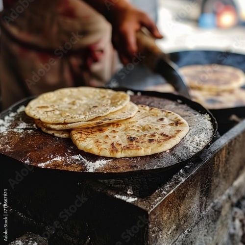 A person is cooking tortillas on a pan