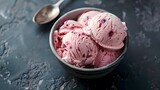 Bowl of Berry Ripple Ice Cream with Silver Spoon on Dark Textured Surface