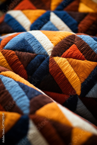 A close-up of a colorful wool blanket with a geometric patten. A textile design element decorated with triangles in shades of orange, blue and brown. AI-generated