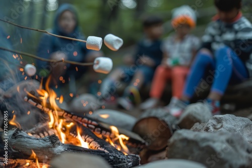 A group of children are sitting around a campfire, roasting marshmallows during a family camping trip