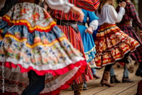 A group of people wearing colorful costumes standing in the dirt at a lively country hoedown