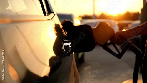 Gas station pump. man filling gasoline fuel with petrol photo