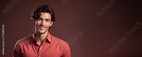 Smiling young Caucasian man in a casual red shirt against a brown background, suitable for lifestyle themes and Valentine's Day promotions