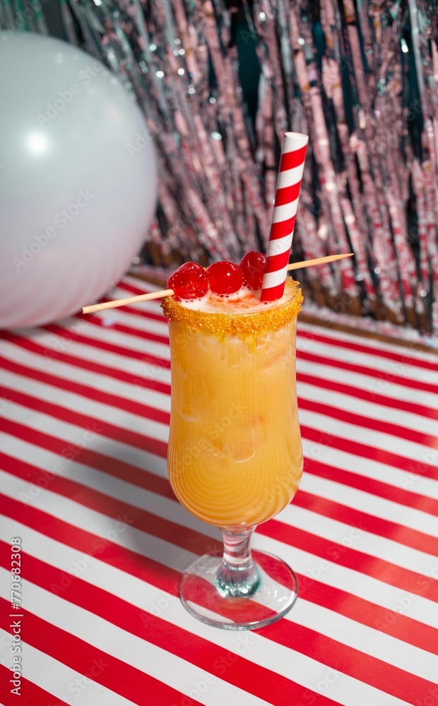 Closeup of a vibrant  fresh cocktail on a surface with a colorful background - obrazy, fototapety, plakaty 