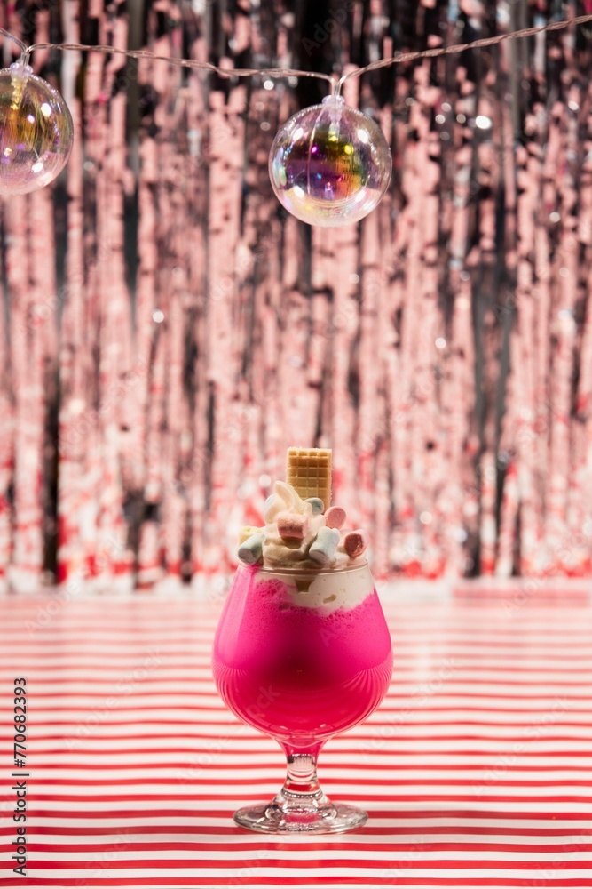 Closeup of a vibrant  fresh cocktail on a surface with a colorful background - obrazy, fototapety, plakaty 