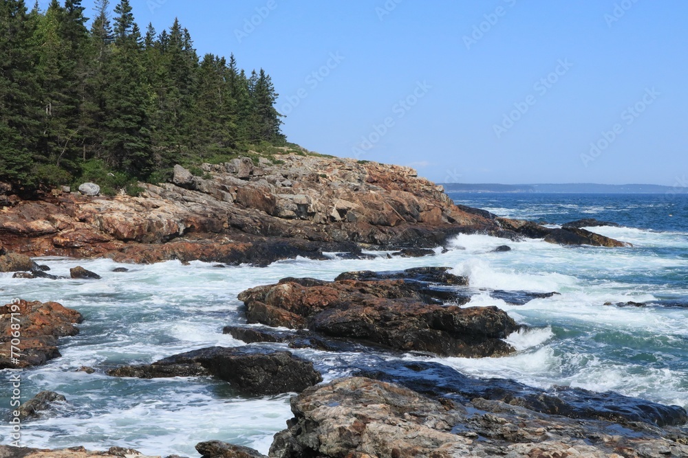 Beautiful coastal landscape with a rocky shoreline and ocean waves in Acadia National Park