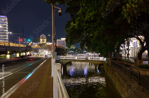 Guangzhou, Canton, China : Night view of the Lizhiwan or Liwan Canal in Guangzhou, Canton, China. Illuminated old stone bridges. Banyan or banian trees on the banks. Buildings. photo