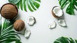 A fresh and minimalist photo of coconuts, tropical fruits and leaves arranged neatly on a white background, space for text capturing the essence of purity and the exotic feel of the tropics.