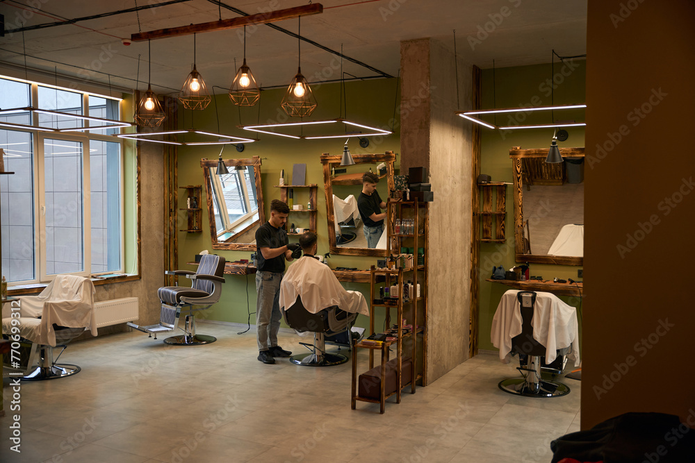 Barbershop interior with working coiffeur
