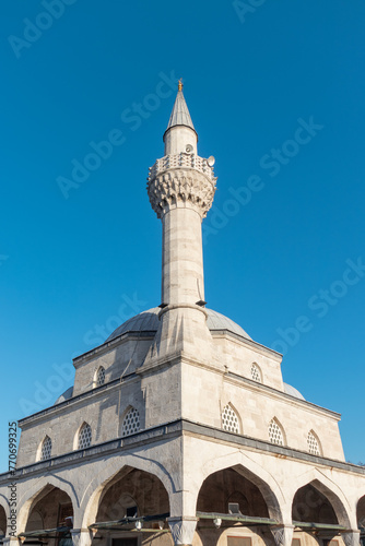 A beautiful mosque at sunset. Şemsi Paşa Mosque, located on the Üsküdar coast of Istanbul. In other words, (Turkish: Kuşkonmaz Camii) Detail view from the dome and minaret. photo