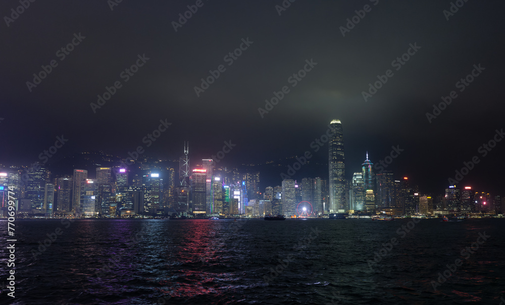 Hong Kong, China : panoramic night shot of Honk Kong from the Tsim Sha Tsui Promenade. Illuminated skyscrapers.