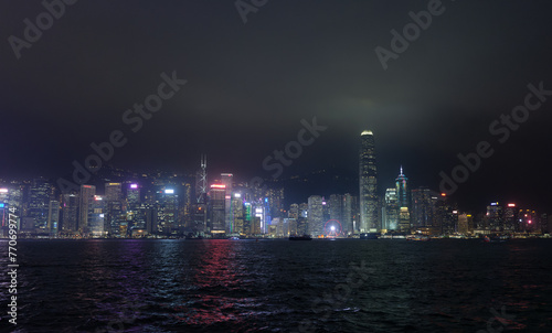 Hong Kong, China : panoramic night shot of Honk Kong from the Tsim Sha Tsui Promenade. Illuminated skyscrapers.