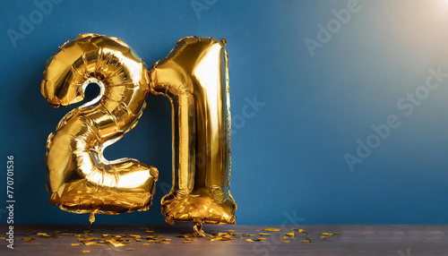 Banner with number 21 golden foil balloon with copy space. Twenty one years anniversary celebration.