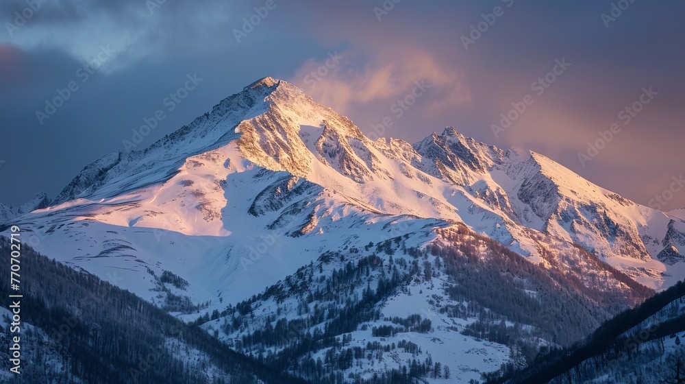 Awakening Wilderness: First Light Shining on Snow-Covered Mountains Amidst a Tranquil Forest