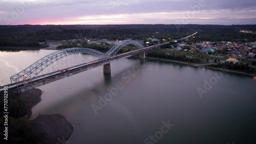 Drone footage of Sherman Minton Bridge spanning the Ohio River at sunset in Indiana, USA photo