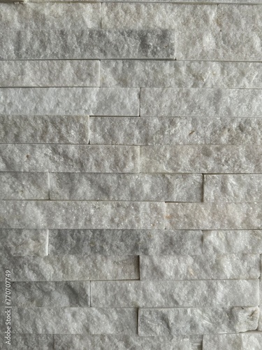 natural white stone wall with thin brick background