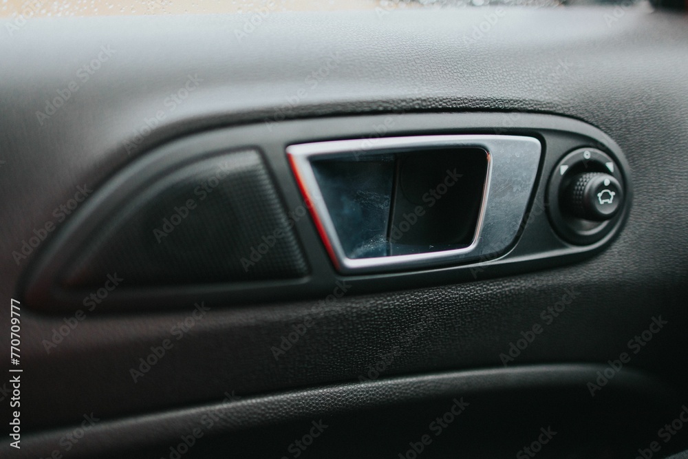 Close-up shot of the handle of a car door from the interior