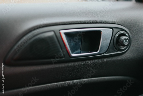 Close-up shot of the handle of a car door from the interior