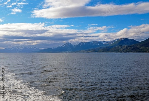Expansive Beagle Channel, surrounded by snow-capped mountain peaks, providing a stunning landscape