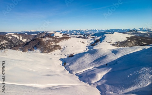 View of a mountainous landscape with a deep valley and snow-covered peaks, Montenegro
