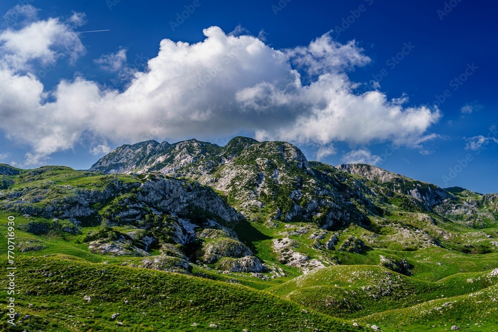 Majestic mountainous area with clouds and a stunning blue sky, Durmitor national park, Montenegro Majestic mountainous area with clouds and a stunning blue sky, Durmitor national park, Montenegro