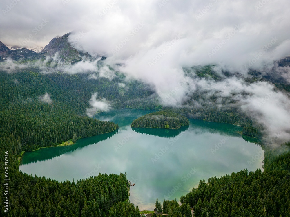 Scenic aerial view of Lake Piva and cloudy mountains