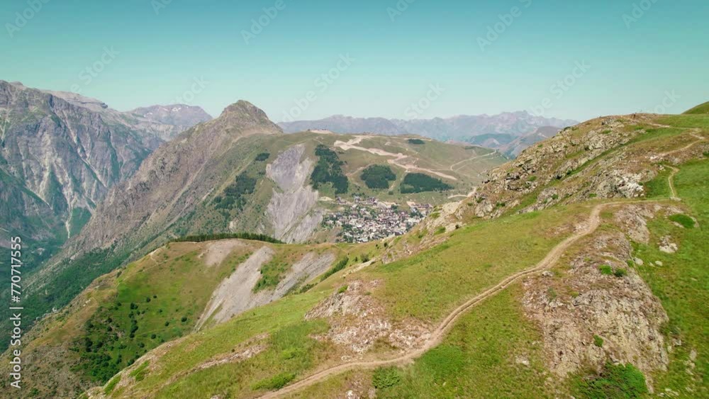Aerial video of the rocky mountains covered with green grass