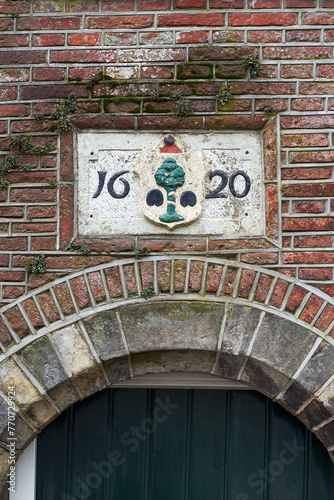 Obraz na płótnie Delft, the Netherlands. 17th century sign on the old building stating the construction date year 1620. w salonie