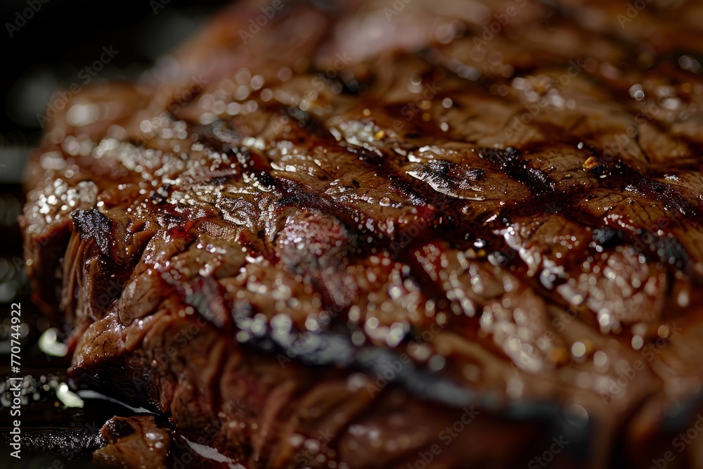 A close-up shot of a juicy beef steak sizzling on a grill, showcasing the grill marks and mouth-watering texture