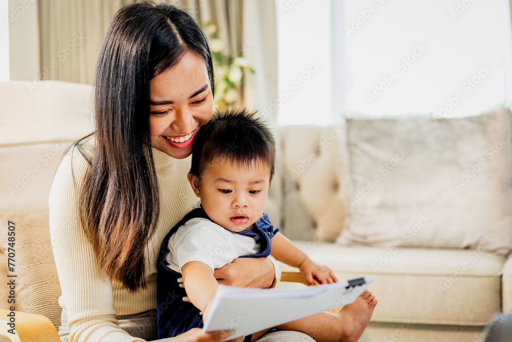 The happiness of mother and child being together every moment. warm family pictures While mother is working from home The happiness of mother and child being together every moment. warm family pictures While mother is working from home