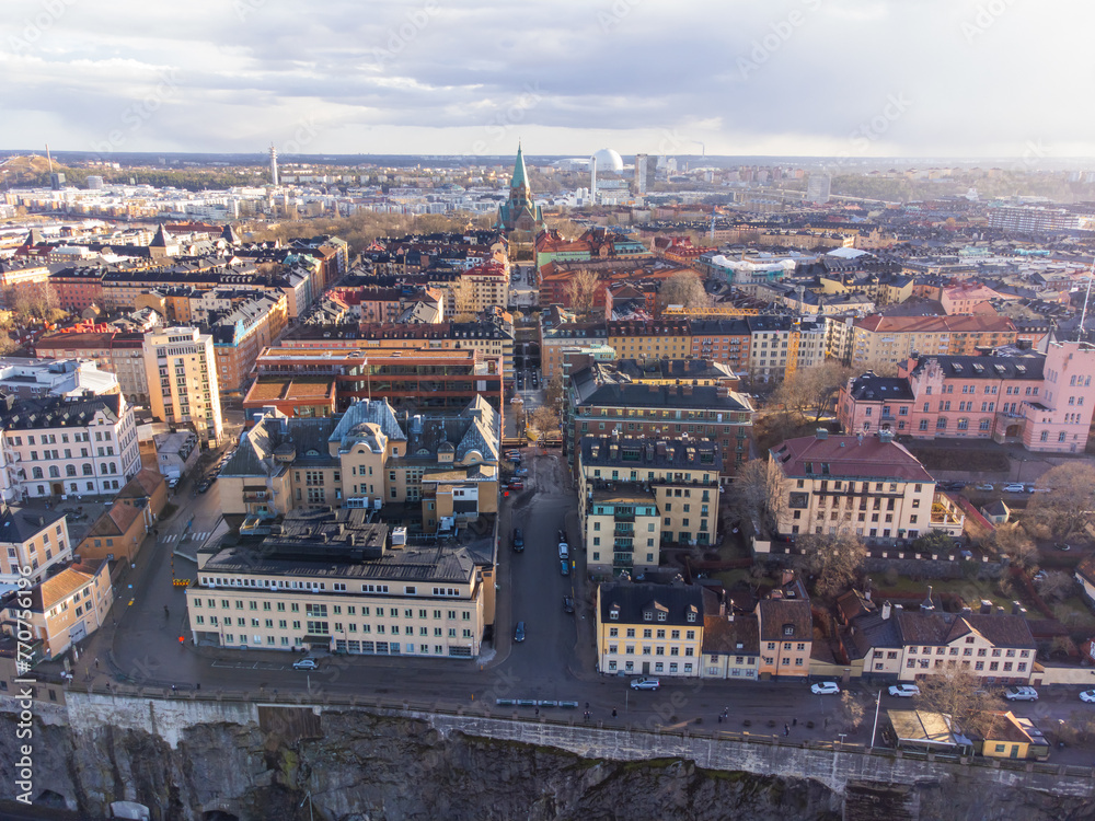 Naklejka premium Aerial view of Stockholm, Södermalm district. Katarina church, Globen and historical buildings after a rainstorm, early spring. Sunshine, partly cloudy.